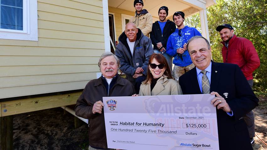 Habitat for Humanity receives check from Sugar Bowl officials for $125,000.